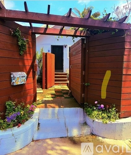 A wooden gate with a yellow number 7 on it.