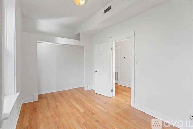 A room with wooden floors and white walls.