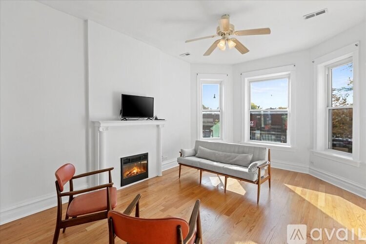 A living room with a fireplace, a television, and a couch.