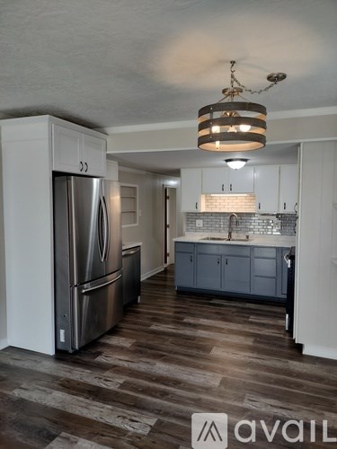 A kitchen with a refrigerator and a countertop.