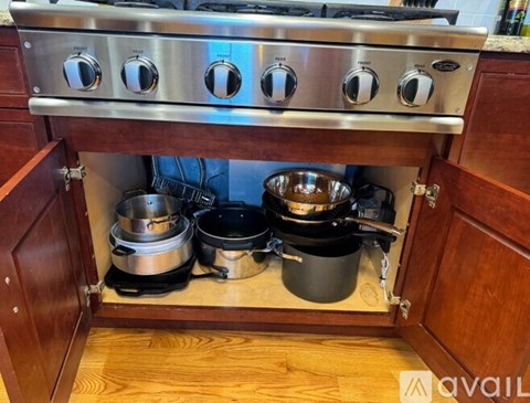A stainless steel stove top with four burners and a pot on the left side.