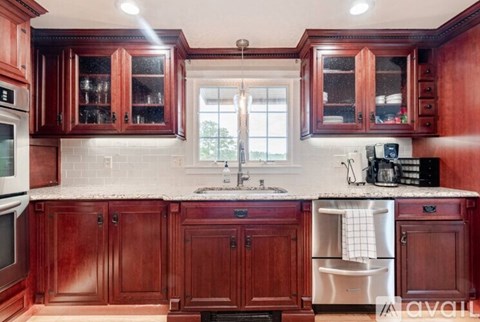 A kitchen with wooden cabinets and a white countertop.
