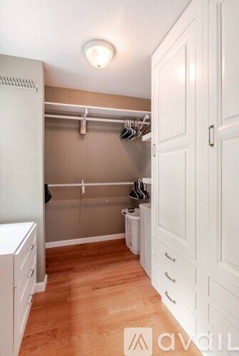 A white closet with a white door and a white cabinet.