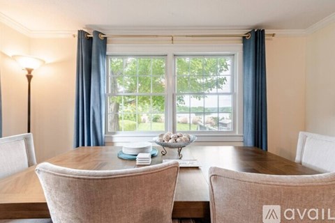 A dining room with a table set for four.