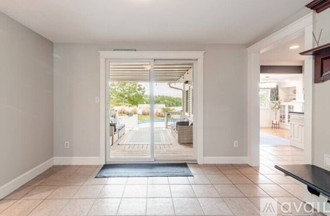 A room with a sliding glass door leading to a patio.