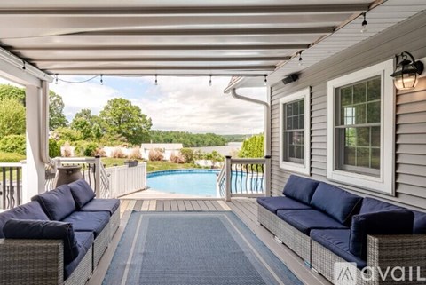 A patio with a pool and a couch.