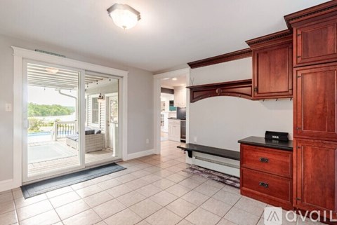 A kitchen with wooden cabinets and a white countertop.
