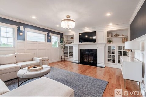 A living room with a fireplace and a white couch.