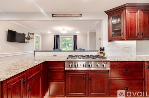 A kitchen with wooden cabinets and a granite countertop.