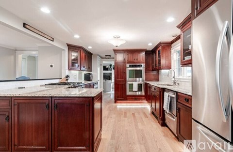 A kitchen with wooden cabinets and stainless steel appliances.