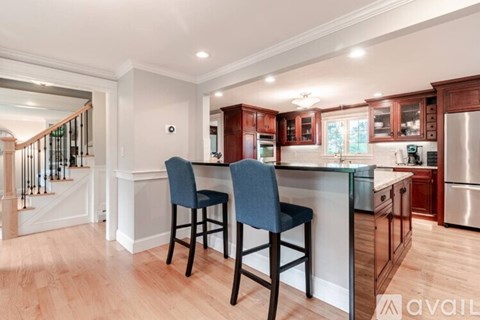 A kitchen with a bar stool and a counter.