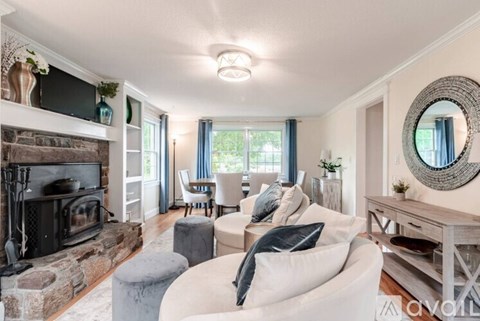 A living room with a fireplace and a white couch.