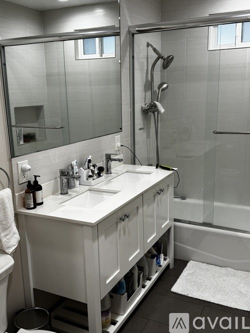 A bathroom with a white sink and a mirror above it.