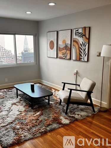 A living room with a black coffee table and a white chair.