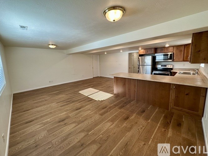 A kitchen with wooden floors and a countertop.