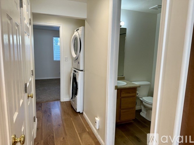 A small laundry room with a washer and dryer.