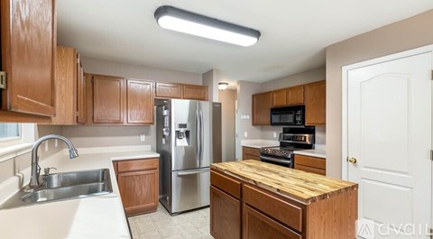 A kitchen with wooden cabinets and stainless steel appliances.