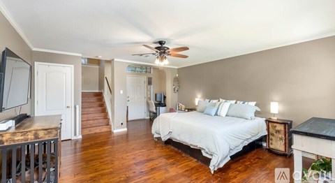 A bedroom with a bed, dresser, and mirror.