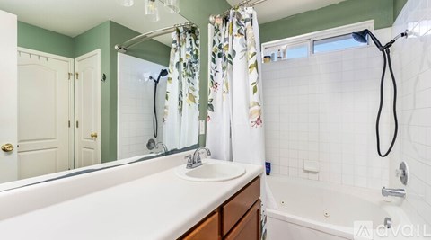 A bathroom with a white sink and a white bathtub.