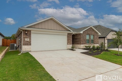 A house with a garage and a driveway in front.