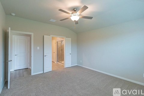 A room with a ceiling fan and carpeted floor.