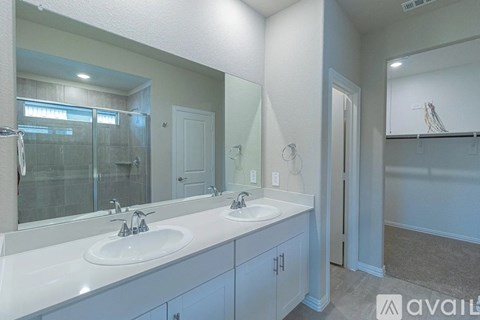 A bathroom with two sinks and a large mirror.