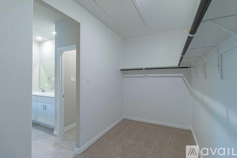 A room with a carpeted floor and a white door.