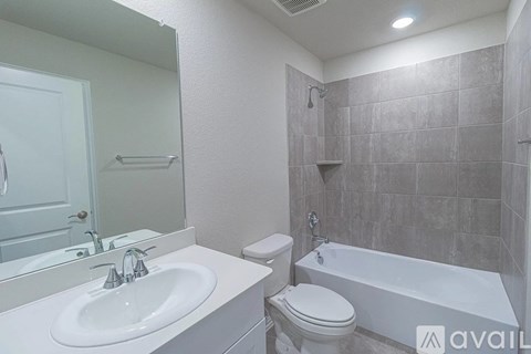 A bathroom with a white sink, toilet, and bathtub.