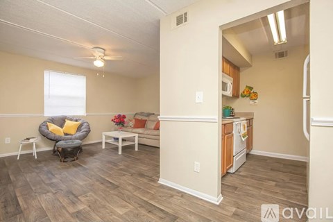 A living room with a grey chair and a white table.