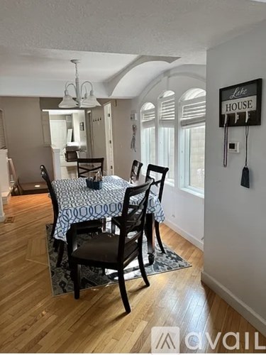 A dining room with a table and chairs.