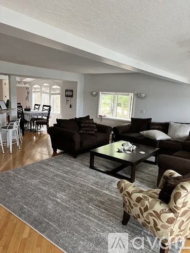 A living room with a brown couch and a coffee table.