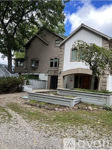 A house with a brown roof and a white garage door.