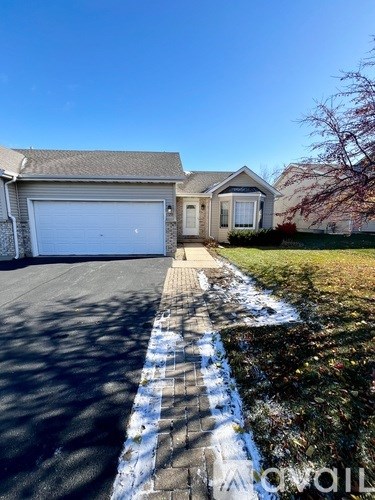 A house with a driveway and garage door.