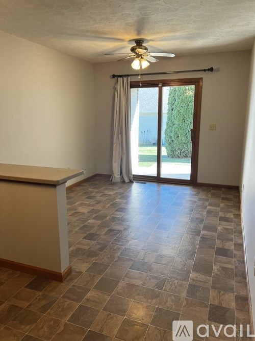 A room with a tiled floor and a ceiling fan.