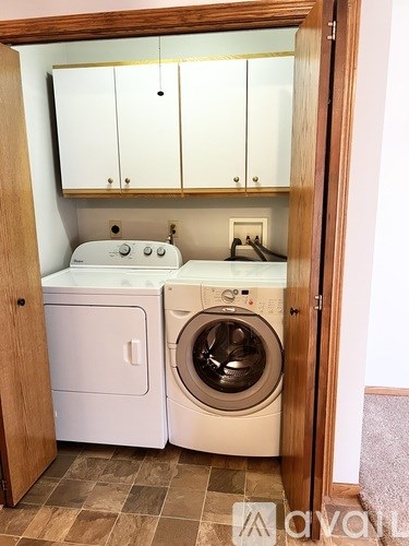 A small laundry room with a washer and dryer.