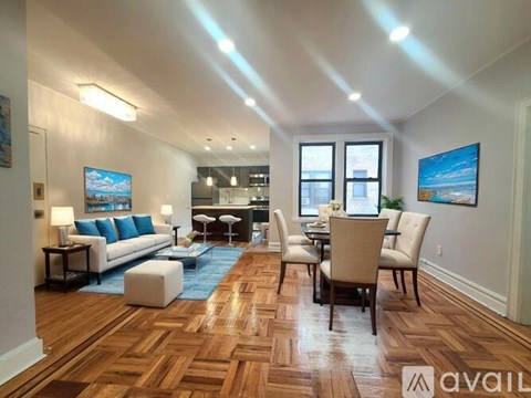 A living room with a white couch, a coffee table, and a dining table with chairs.