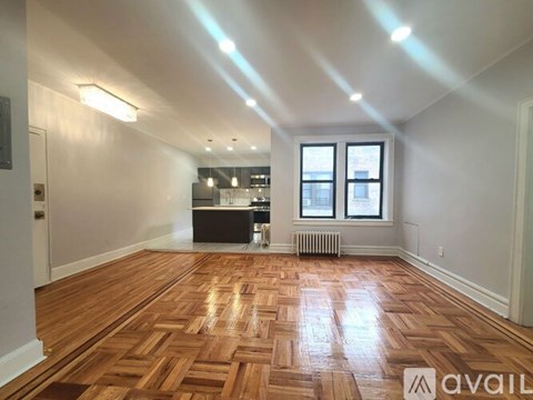 A room with wooden flooring and a window.