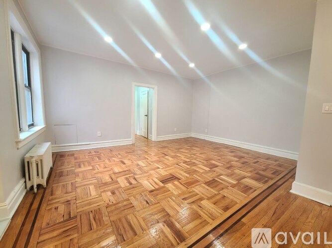 A room with wooden flooring and skylights.