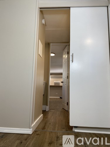 A hallway with a white door on the right.