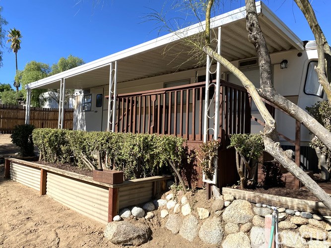 A house with a brown fence and a stone wall.