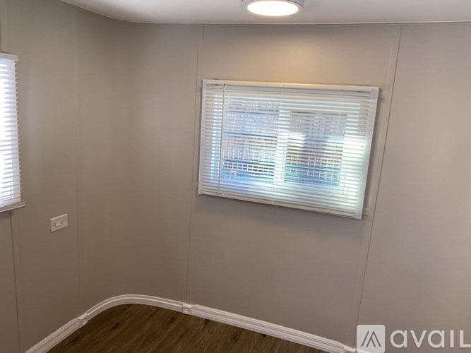 A room with a window covered in blinds.