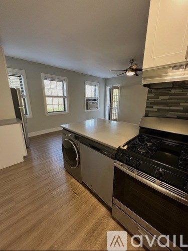 A kitchen with a stove top oven and a dishwasher.