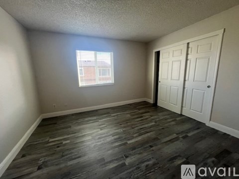 A room with a window and a door is available for rent.