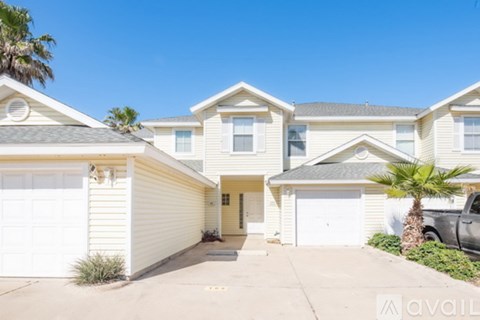 A row of houses with a clear blue sky above them.