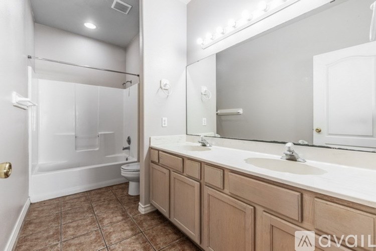 A bathroom with a brown floor and white walls.