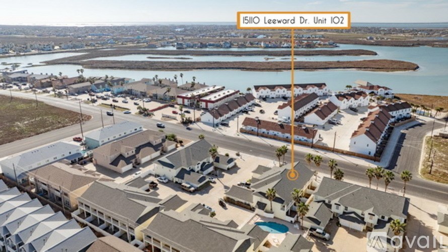 A bird's eye view of a residential area with a sign reading "5110 Leeward Dr. Unit 102".