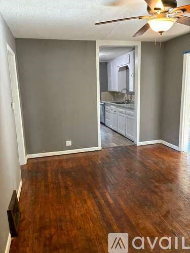 A room with wooden floors and a ceiling fan.