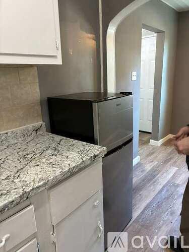 A kitchen with a granite countertop and stainless steel appliances.
