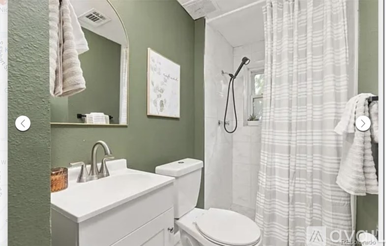 A white toilet sits next to a sink in a bathroom.