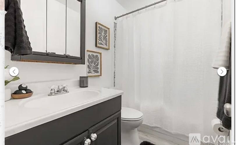 A bathroom with a white sink and a white toilet.